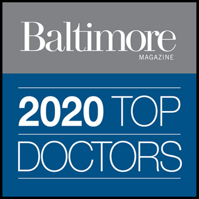 The image features the cover of Baltimore Magazine s October 2021 issue, highlighting the magazine s recognition of top doctors in the city.